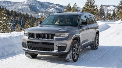 A car hire SUV driving on a winding, snowy road through the Catskills mountains in New York during winter