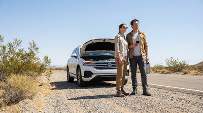 A car hire vehicle pulled over on a scenic desert highway with red rock mountains outside Las Vegas