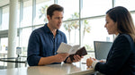 Traveler presenting a driving permit to an agent at a car rental desk in California