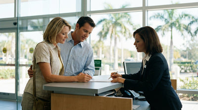 A red convertible car rental driving on a sunny coastal highway lined with palm trees in Florida