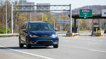 A driver in a car rental approaching an electronic highway toll booth in Pennsylvania