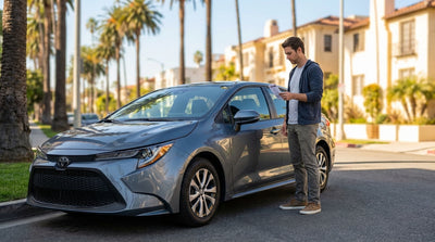 A parking ticket on the windshield of a car hire vehicle parked on a sunny street in California