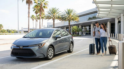 A row of vehicles at a car hire pickup bay in a sunny Orlando airport parking garage