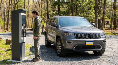 A modern car rental parked in a wooded lot at a Pennsylvania state park during a sunny autumn day