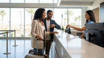 A traveler receives keys for their car rental at a busy counter inside the Las Vegas airport