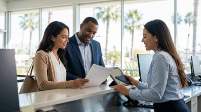 A modern car rental driving along a sunny, winding coastal highway in Big Sur, California