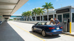 A row of modern vehicles ready for car hire at a sunny Florida airport rental location