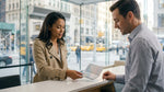 Person handing a passport and driver's licence to an agent at a New York car hire counter
