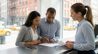 A customer carefully reviews a car rental agreement form at an office desk in New York