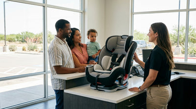A father installs a child safety seat in the back of a family car hire on a sunny day in Texas