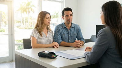 A white convertible car hire parked on a road overlooking a beautiful sunny beach in Florida