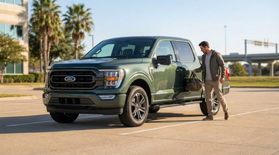 A modern car hire vehicle parked on the side of a scenic highway overlooking the vast Texas Hill Country at golden hour