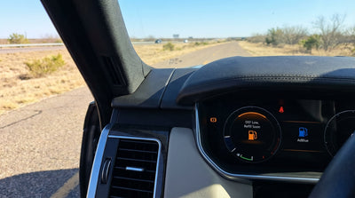 Close-up of a DEF warning light illuminated on the dashboard of a car rental in Texas
