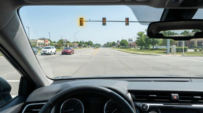 A flashing yellow left-turn arrow at a Texas intersection as seen from the driver's seat of a car hire