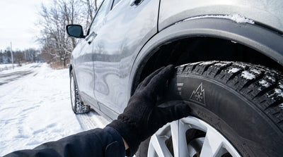A car rental driving on a winding, snow-covered road through a forest in upstate New York