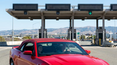 A car rental driving across the Golden Gate Bridge in San Francisco on a sunny day