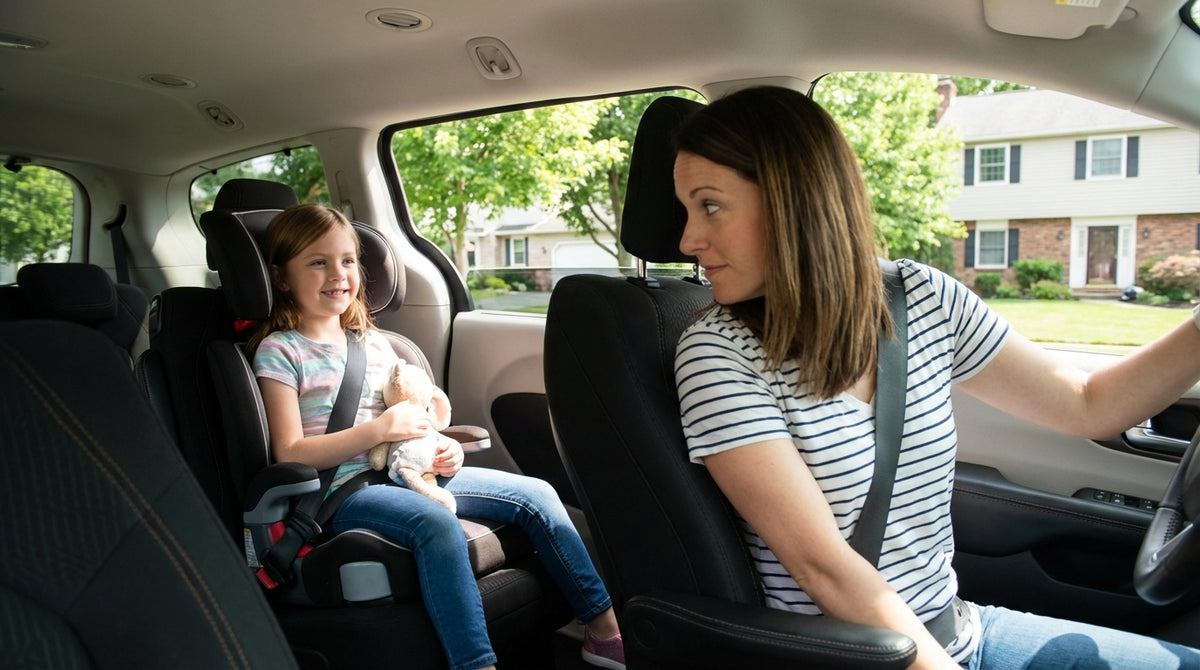 A young child smiles from a booster seat in a car rental driving through the scenic Pennsylvania countryside