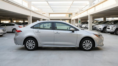 Rows of cars available for car rental in a well-lit parking garage at the San Francisco airport