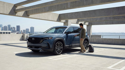 A car hire parked along the San Francisco waterfront with Alcatraz Island visible across the bay