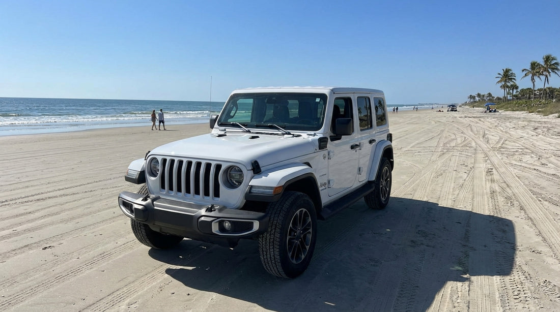 A modern car hire vehicle parked on the famous drive-on sand of Daytona Beach, Florida with the ocean behind