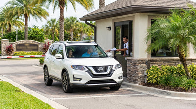 A car hire stopped at the security entrance of a palm-lined gated community in Orlando
