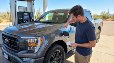 A diesel pickup truck, a popular Texas car rental, drives along a highway