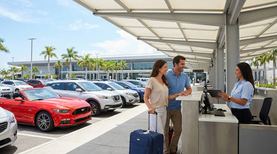 A row of cars in a sunny car hire parking lot at LAX airport in Los Angeles