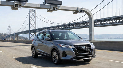 A car hire driving across the San Francisco Bay Bridge toward the downtown skyline on a sunny day