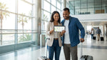 Passenger holding a smartphone next to a white car rental vehicle at Miami Airport