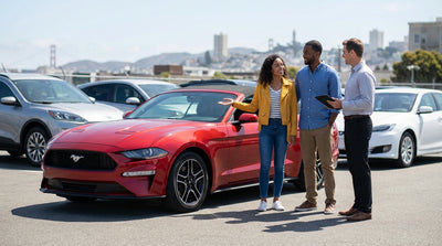 A red convertible car hire parked at a viewpoint overlooking the Golden Gate Bridge in San Francisco