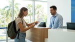 Customer receiving keys and signing paperwork at a car rental desk in Orlando