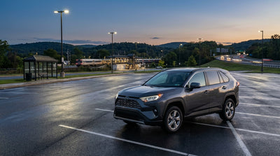 A modern car rental parked in a space at a park-and-ride lot in Pennsylvania on a sunny day