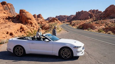 A car hire driving on a winding road through the red rock formations of Valley of Fire near Las Vegas