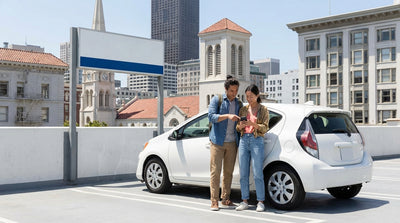 A person in a convertible car hire driving across the Golden Gate Bridge in San Francisco on a sunny day
