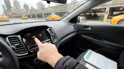 A car's dashboard with an illuminated warning light, part of a car hire service in New York