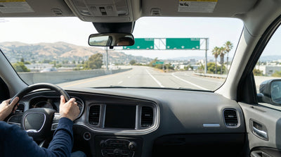A car hire driving on a highway towards the downtown San Francisco skyline on a sunny day