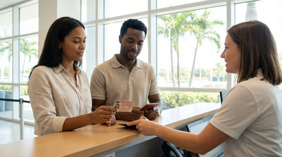 A red convertible car rental driving down a sunny, palm-tree-lined road in Florida