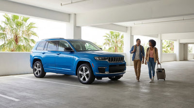 A car hire approaches the iconic Universal Orlando globe and parking entrance on a sunny day