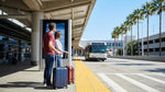 A car rental shuttle bus waits for passengers outside Terminal 1 at LAX in Los Angeles