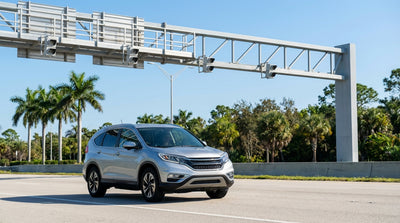 A white convertible car rental driving across a scenic ocean bridge in Florida