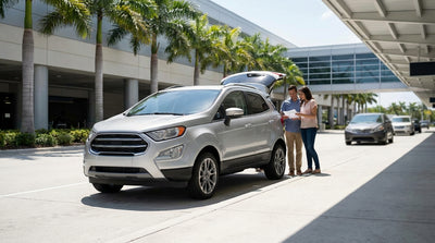 A convertible car rental drives down a scenic coastal highway in Florida, with palm trees and a sunny blue sky