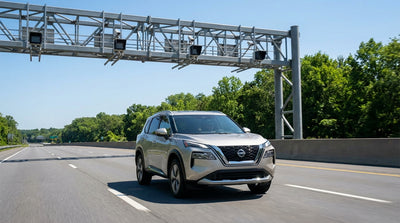 A car hire driving on a highway with the Philadelphia skyline in the background on a sunny day