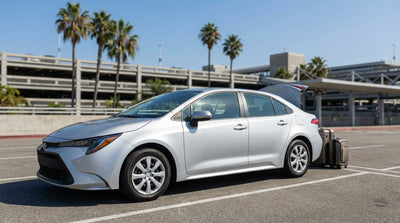 A long row of clean cars ready for airport car rental on a sunny day in California