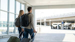 A traveler approaches the car hire desks inside the brightly lit Dallas Love Field Airport rental center in Texas