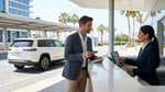 Close-up of a person handing a credit card to an agent at a car hire desk in Miami