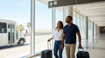 Traveler with a suitcase walking toward a shuttle bus outside a Las Vegas car rental center