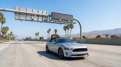 View from a car rental of traffic on a sunny Los Angeles freeway with an express lane toll sign
