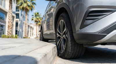 A driver inspects a torn tire sidewall on their car rental on a street in Las Vegas