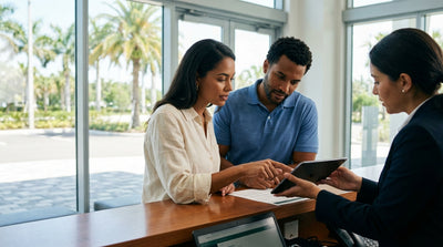 A red convertible car rental driving along a sunny coastal highway in Florida with palm trees