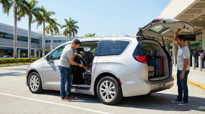 A happy family stands by their white SUV car hire in Miami with a child seat installed in the back